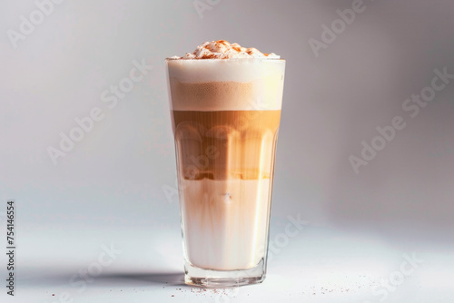 delicious Latte - A shot of espresso with steamed milk and a light layer of foam served in a tall glass