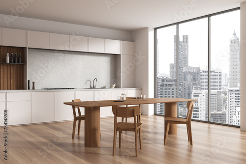 Beige home kitchen interior with eating table and chairs, panoramic window © ImageFlow