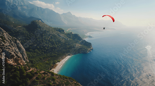 Person parasailing over scenic coastline © Matthias