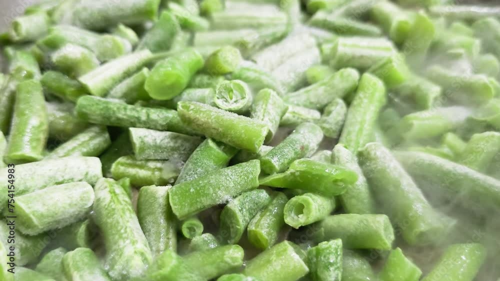 frying green beans on skillet, full-frame closeup view with selective focus. frying green beans on skillet, full-frame closeup view with selective focus.