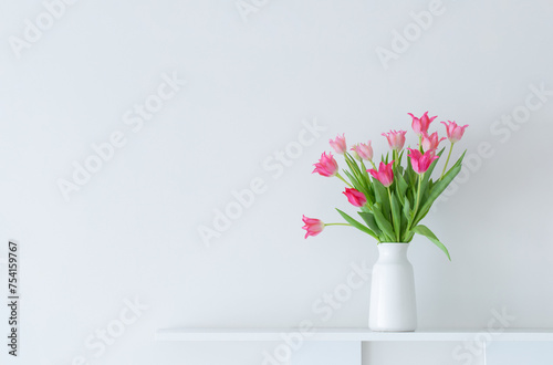 Fototapeta Naklejka Na Ścianę i Meble -  pink tulips in white vase on white background