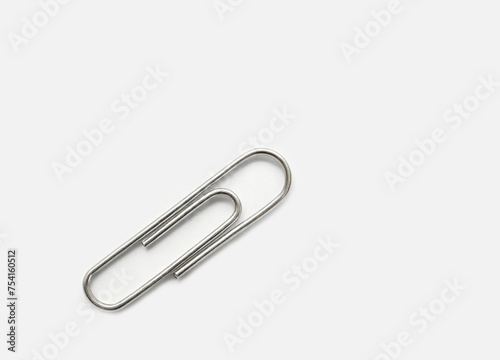 A silver clip is sitting on a white background