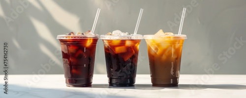 Three cups of iced coffee mockup with colored straws on a white background.
