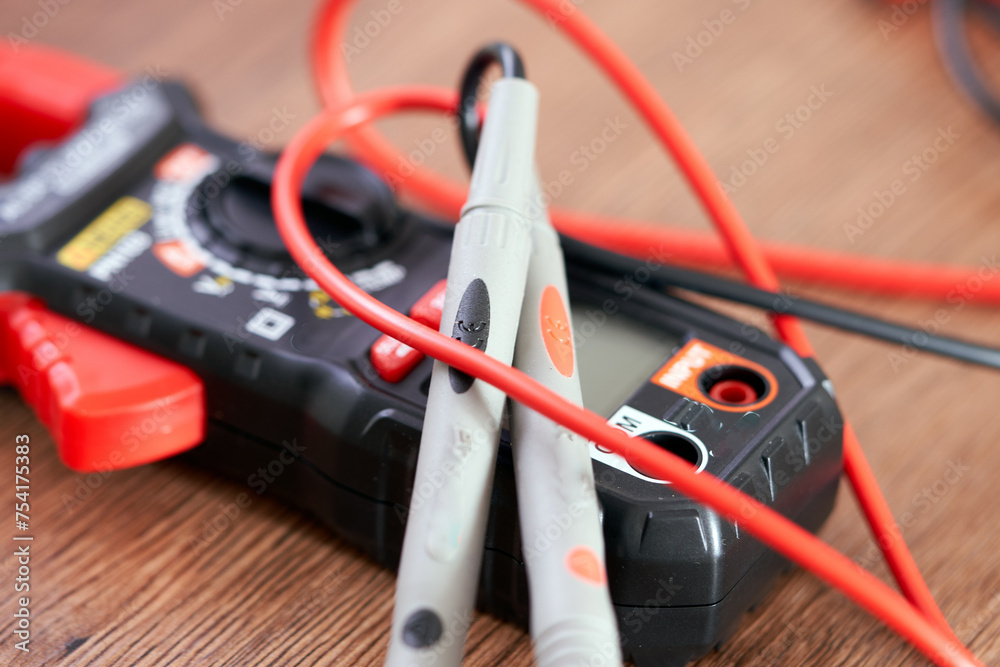 A screwdriver lies on a multimeter measuring device A screwdriver lies on a multimeter measuring device