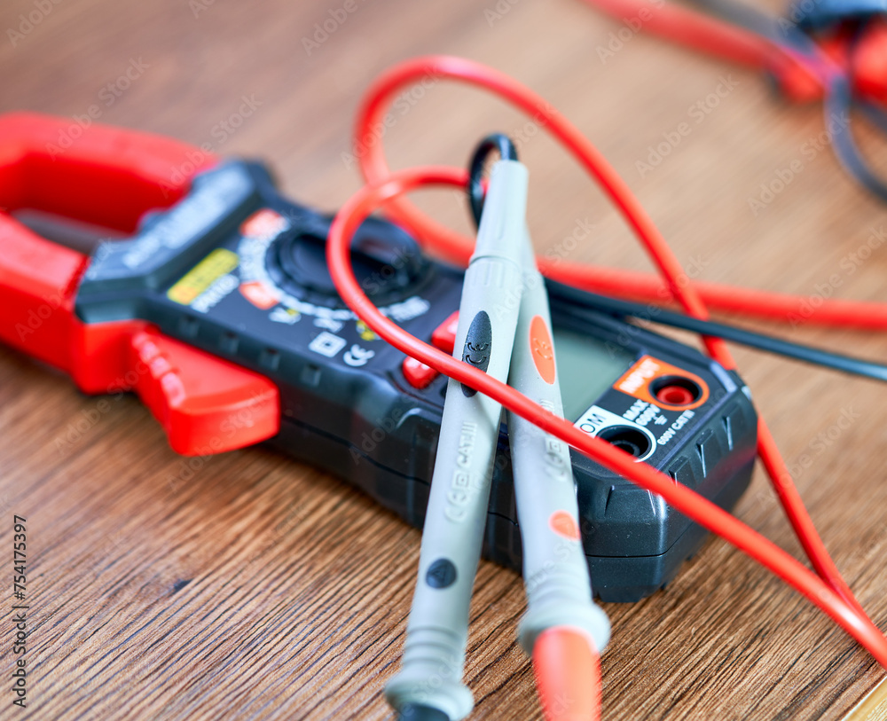 A screwdriver lies on a multimeter measuring device A screwdriver lies on a multimeter measuring device
