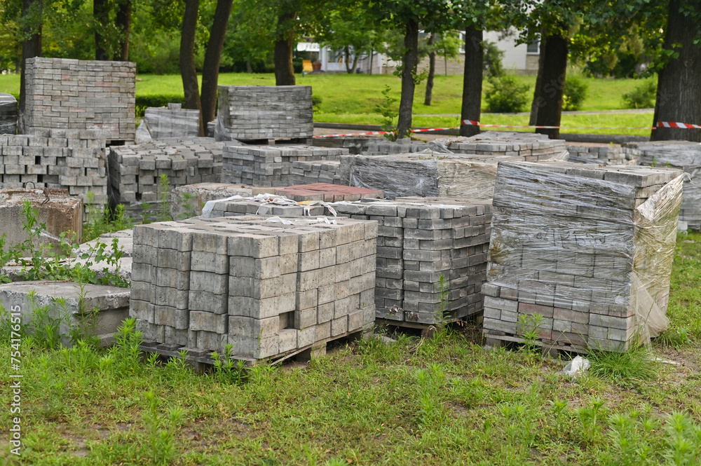 Gray bricks are stacked into cubes. White blocks of brick in stock on Warehouse bricks. Gray bricks are stacked into cubes. White blocks of brick in stock on Warehouse bricks.