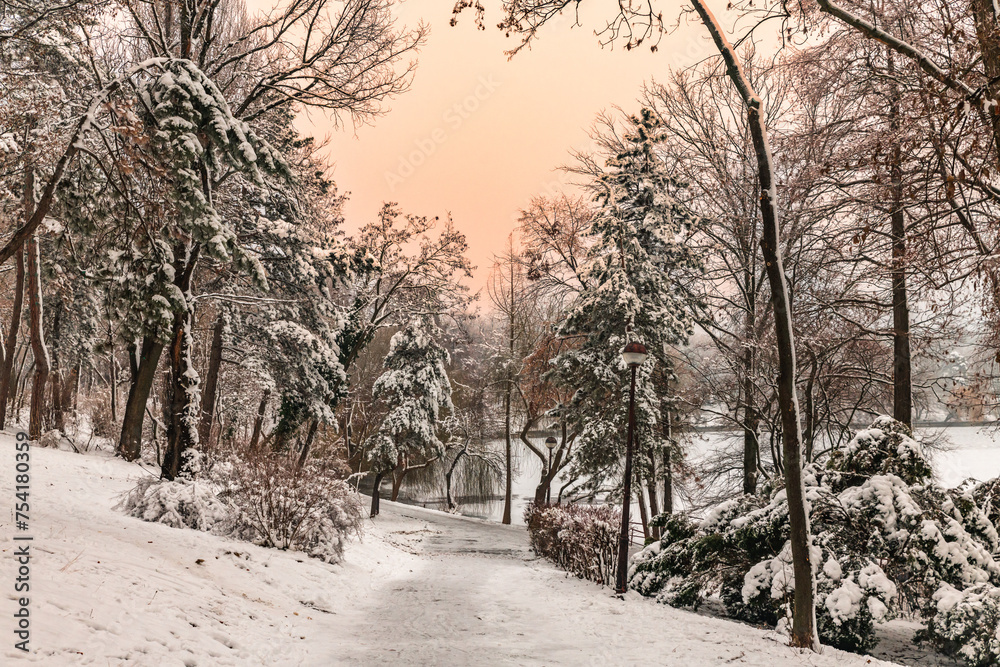 Winter snowy time in a park in Bucharest Romania sunset colors