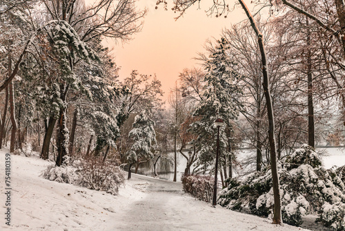 Obraz na płótnie Winter snowy time in a park in Bucharest Romania sunset colors w salonie