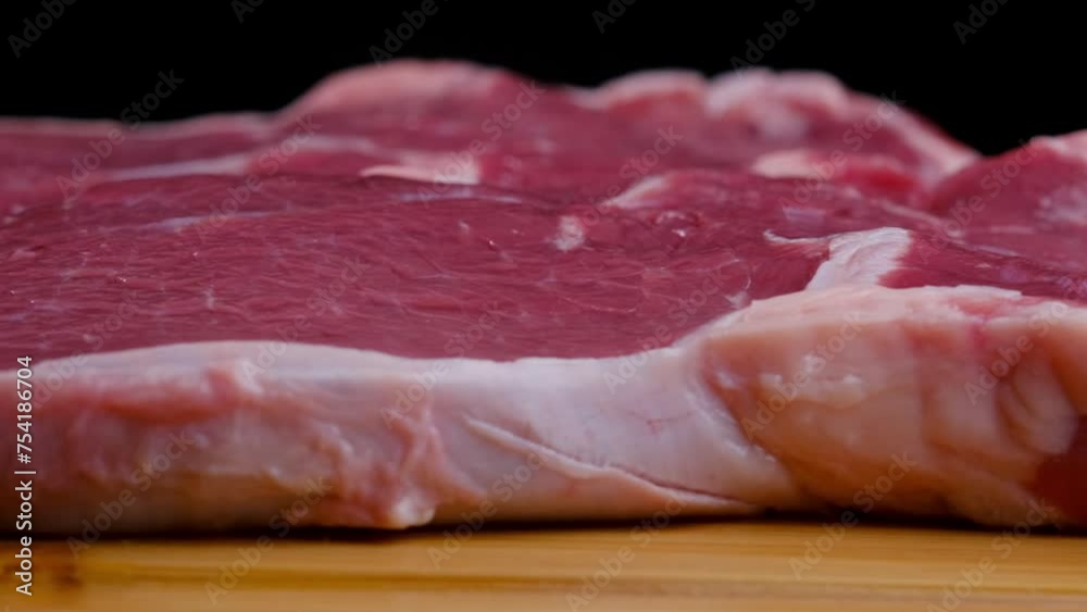 Raw beef steak spinning close-up