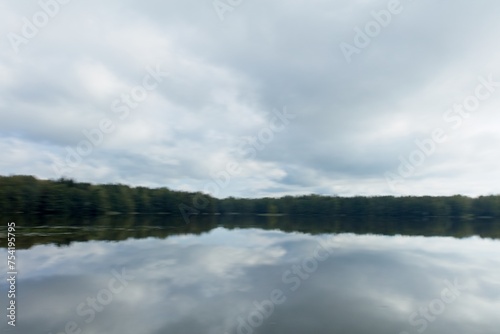 ICM abstract of landscape view of lake, forest and sky with cloudy sky reflection water surface.