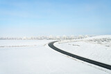Highway leading through a snowy winter landscape