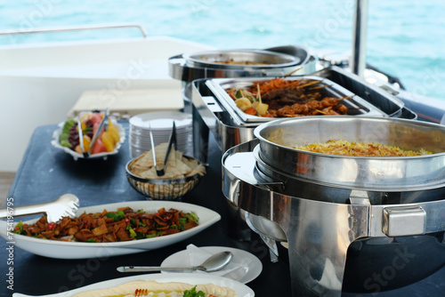 Gourmet Buffet Spread on a Yacht Cruise. A delicious buffet spread on a yacht with an array of dishes ready to be served to guests at sea.