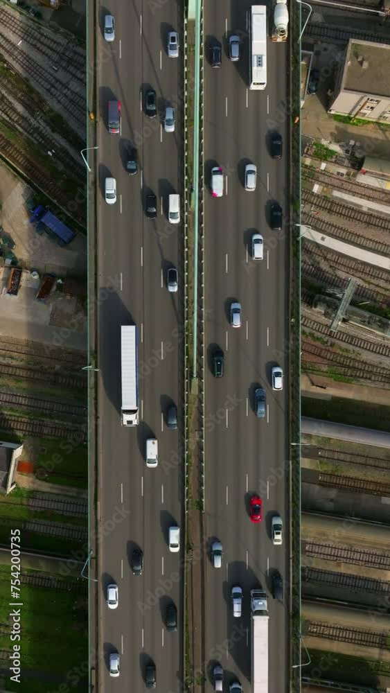 Cars are moving in heavy traffic on the bridge located in the capital of France. Rush hour traffic in the business district of Paris. Drone view of the urban set of cars. Vertical video Cars are moving in heavy traffic on the bridge located in the capital of France. Rush hour traffic in the business district of Paris. Drone view of the urban set of cars. Vertical video