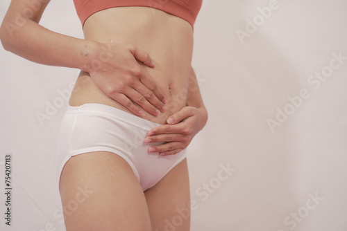 Wallpaper Mural Close-up of woman wearing white panties On a white background about menstruation, cervical cancer, ovarian cancer. Torontodigital.ca