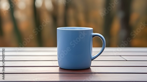 Close up of a blue Mug on a wooden Table in a Forest. Blurred natural Background
