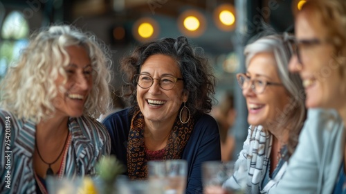 Group of middle-aged women laughing and sharing experiences in a support group setting, emphasizing community and understanding