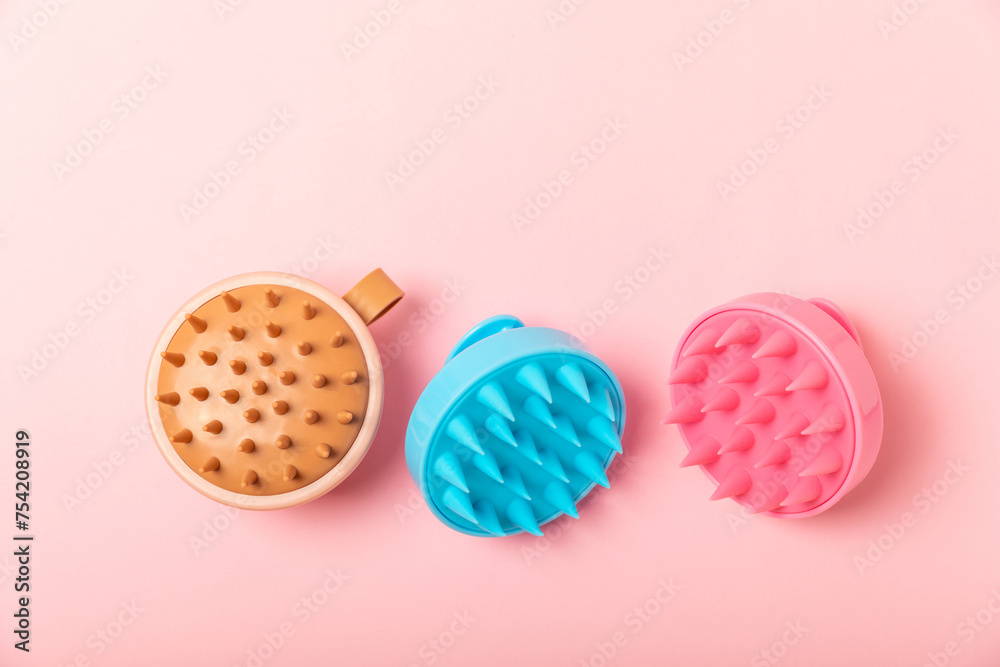 Brush for scalp massage on a pink background. Brush for hair growth stimulating brush. Hair massage. stimulating brush. Hair care, head relaxation concept. Copy space. Brush for scalp massage on a pink background. Brush for hair growth stimulating brush. Hair massage. stimulating brush. Hair care, head relaxation concept. Copy space.
