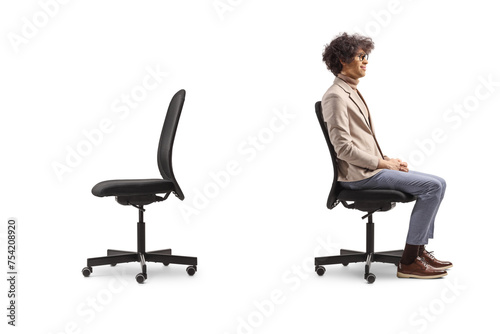 Profile shot of a man sitting in an office chair next to an empty chair photo