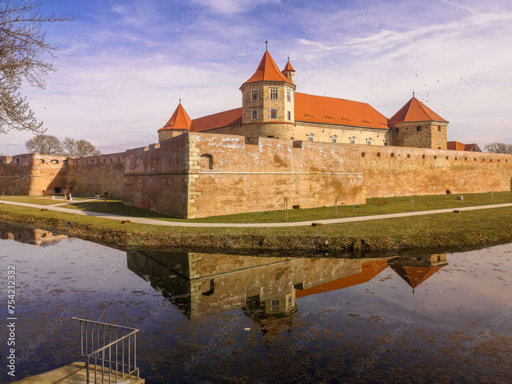 Water reflection with Fagaras Citadel Fortress in Brasov Romania
