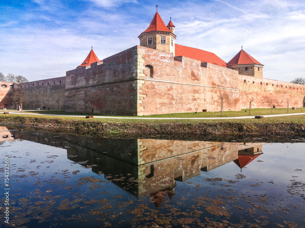 Water reflection with Fagaras Citadel Fortress in Brasov Romania