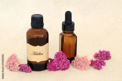 Achillea yarrow herb flower essence for natural herbal medicine with tincture and essential oil bottles. Treats hemorrhoids, wounds, bloating, flatulence. On hemp paper.