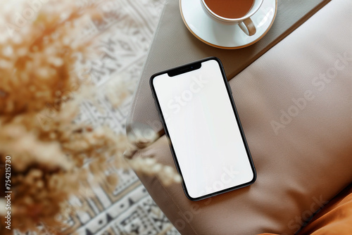 Smartphone blank mockup screen on the table top down view photo