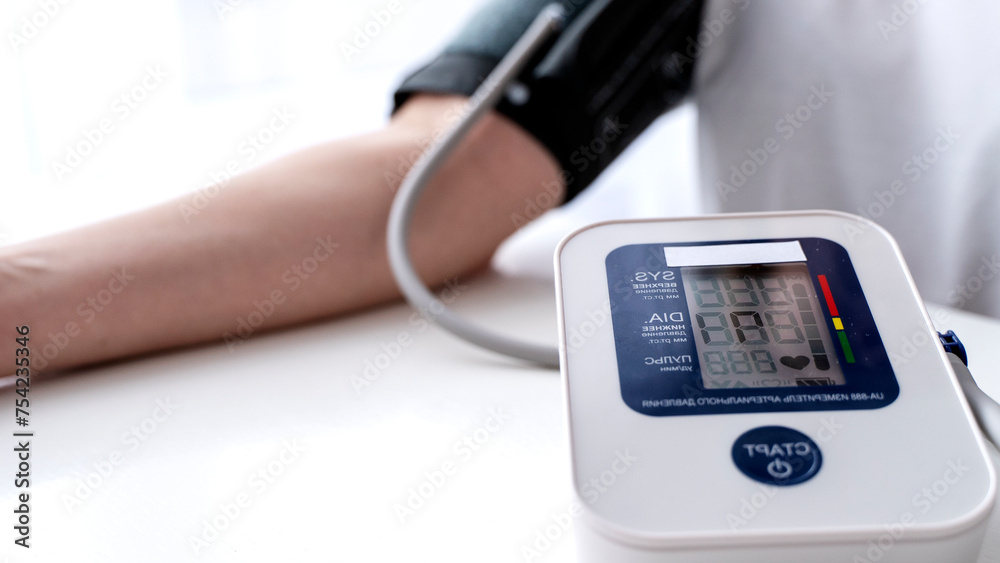 girl measures blood pressure with a tonometer in girl measures blood pressure with a tonometer in