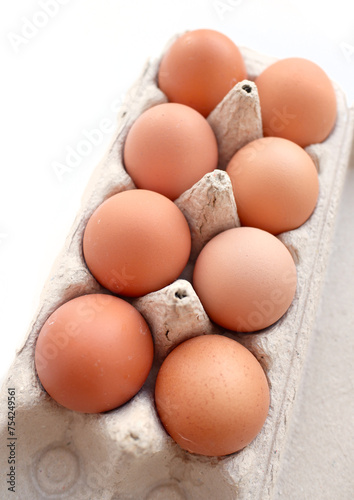 Brown chicken eggs in a box.