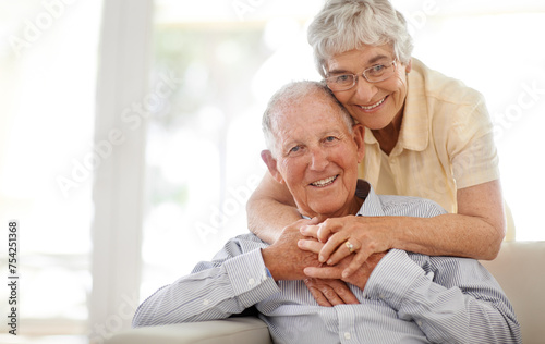 Couple, senior and hug or sofa in portrait, home and relax together for bonding and smile. Elderly people, embrace and care in marriage or relationship in retirement, loyalty and security on couch