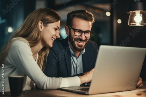 A man and a woman looking at a laptop, suitable for business concepts