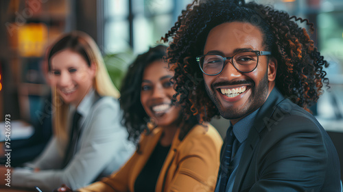 Diverse Business Team Sharing a Joyful Moment . A multi-ethnic group of business professionals laughing together, representing teamwork and positive workplace culture.  © phairot