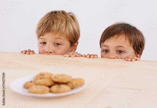 Bilde på lerret Children, table and peeking at cookies for curiosity, observation and sneaking with glance