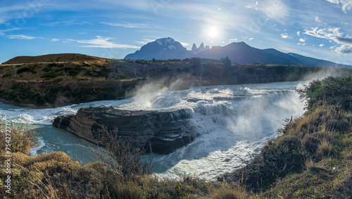 Majestic Waterfall with Mountain Backdrop at Sunrise