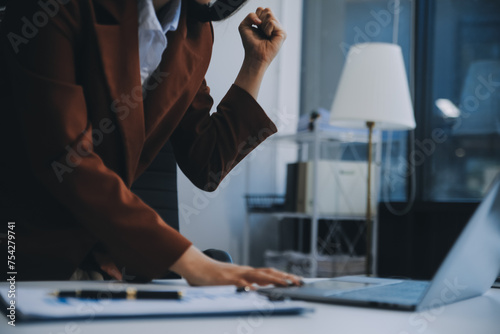 Young attractive businesswoman working on her project with laptop computer in modern office room.