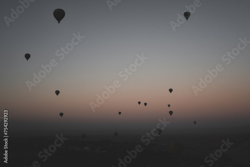 Many Hot air balloons at sunrise floating over the Nile River in Luxor, Egypt