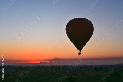 Many Hot air balloons at sunrise floating over the Nile River in Luxor, Egypt