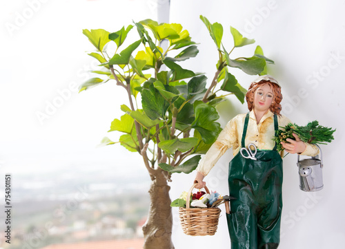 Gardener in uniform, with watering can and basket with flowers
