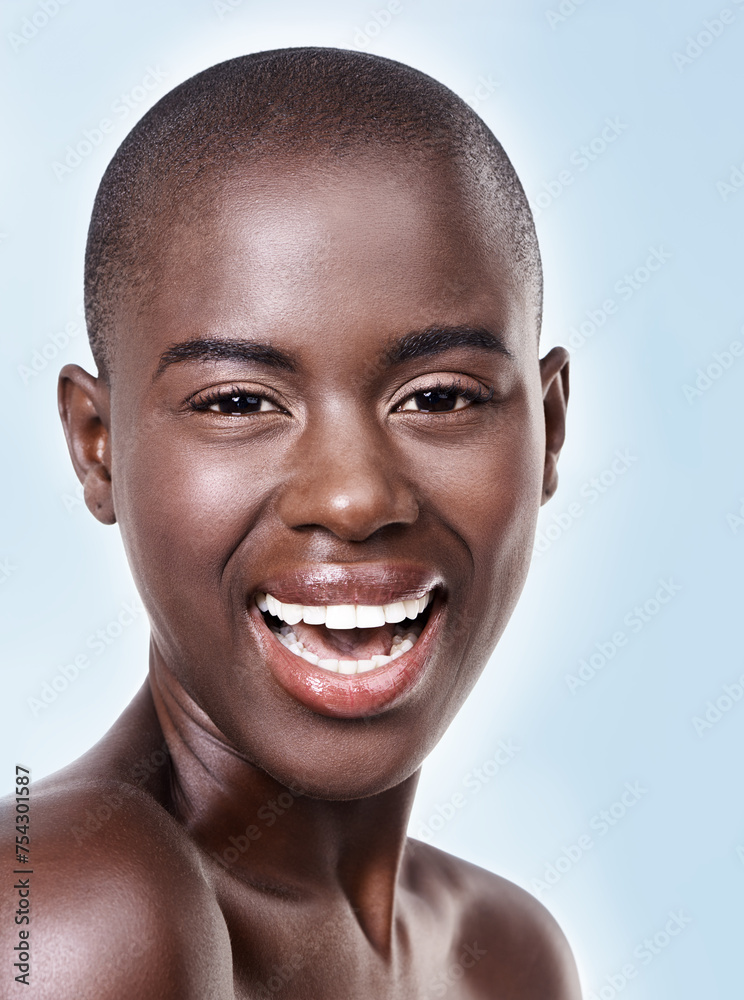 Portrait, beauty and skincare with bald black woman in studio on blue background for natural wellness. Face, smile and aesthetic with happy young model at spa for cosmetics, facial or dermatology Portrait, beauty and skincare with bald black woman in studio on blue background for natural wellness. Face, smile and aesthetic with happy young model at spa for cosmetics, facial or dermatology