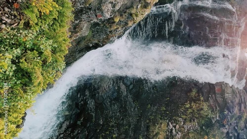 A beautiful waterfall in the autumn mountains beyond the Arctic Circle in the north, in Khibiny, Murmansk region. Panoramic view of a beautiful waterfall in the mountains in autumn, Kola Peninsula 4К photo