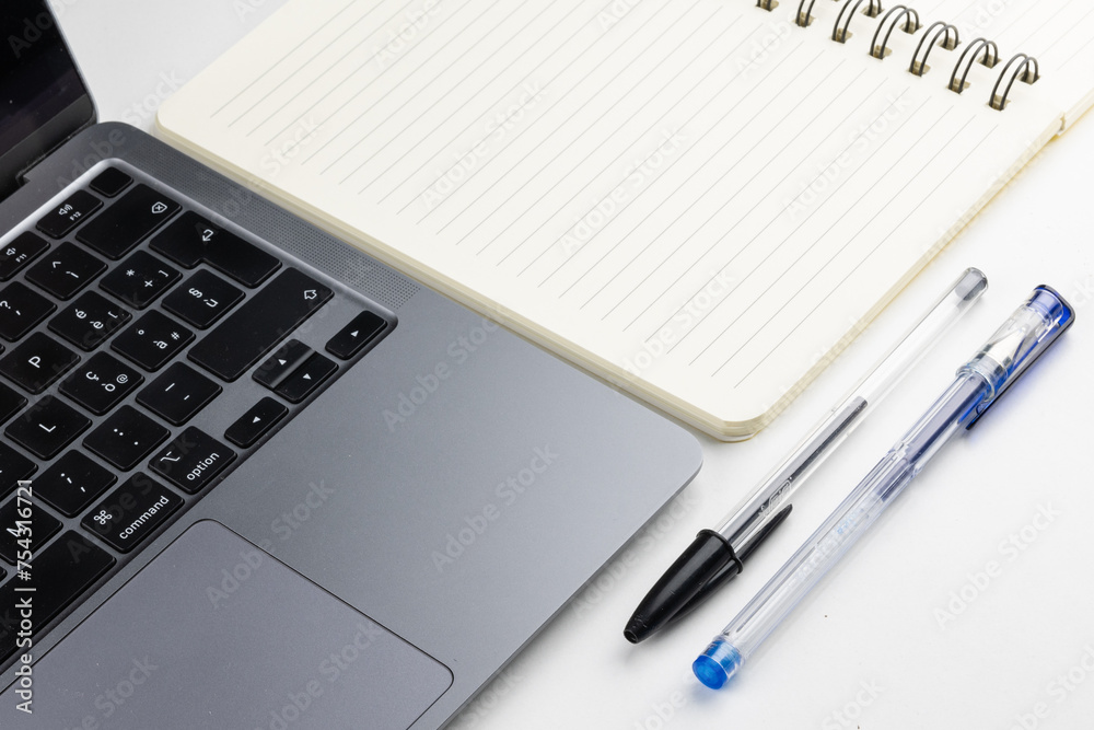 Laptop with block notes and pen Laptop with block notes and pen