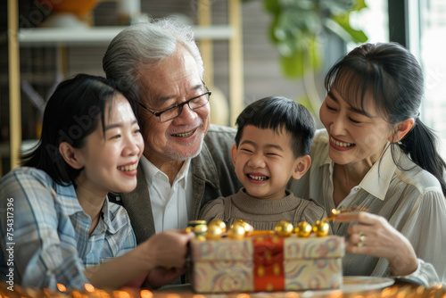 Happy three generation Asian family celebrating grandpa s birthday at home