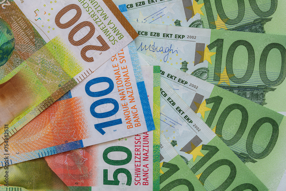 Closeup of 50, 100 and 200 Swiss franc banknotes and 100 euro banknotes Closeup of 50, 100 and 200 Swiss franc banknotes and 100 euro banknotes