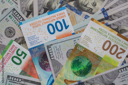 Closeup of 50, 100 and 200 Swiss franc banknotes and 100 dollar banknote photo