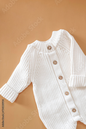 Jumpsuits for newborns on a beige background. Spring clothes for children