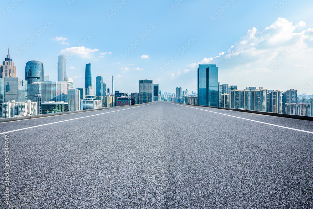 Empty asphalt road and city business buildings skyline Empty asphalt road and city business buildings skyline