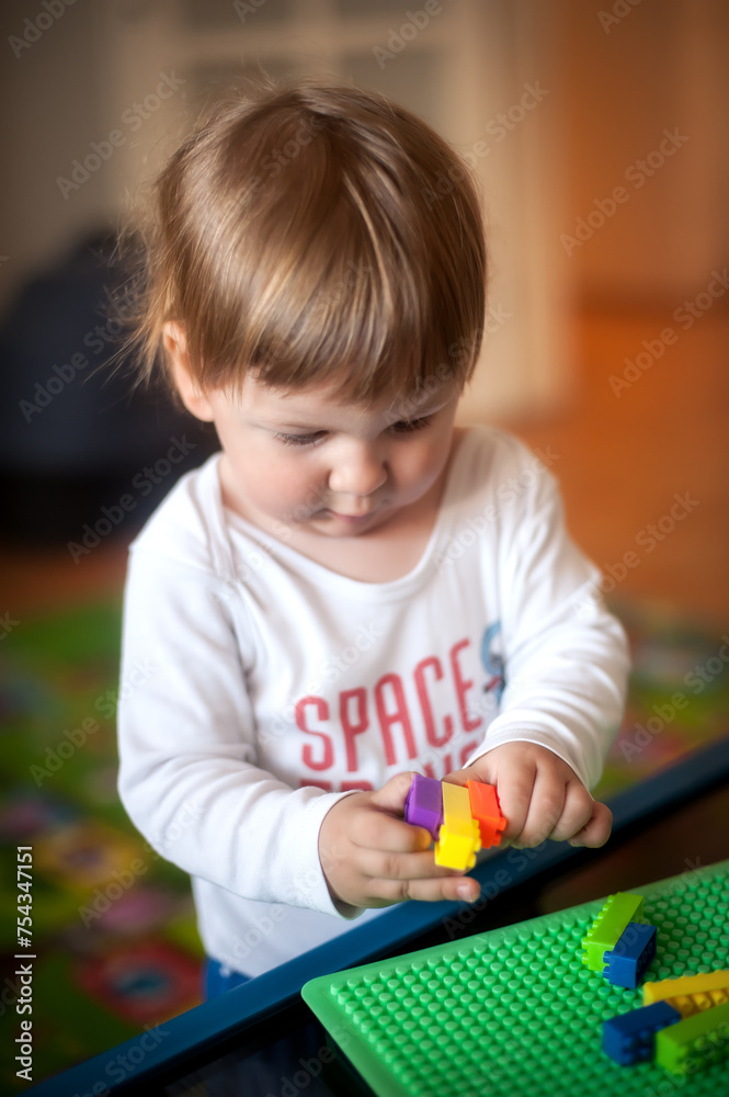 blocks. Happy child, cute toddler boy playing and building with colorful plastic bricks table. Early learning and development blocks. Happy child, cute toddler boy playing and building with colorful plastic bricks table. Early learning and development