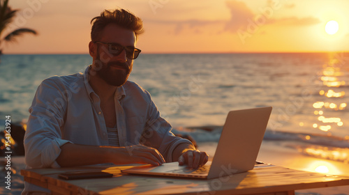 person working on laptop at sunset photo
