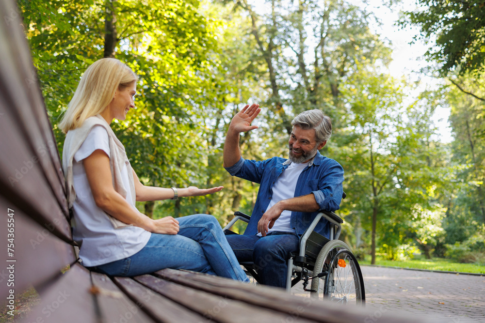 Friendship Knows No Bounds: Woman Cheers Man in Wheelchair Friendship Knows No Bounds: Woman Cheers Man in Wheelchair