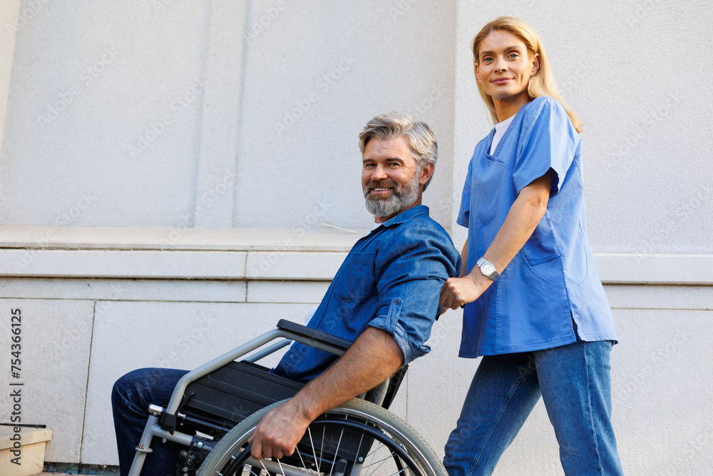 Together Outdoors: Nurse Supports Wheelchair User on a Walk Together Outdoors: Nurse Supports Wheelchair User on a Walk
