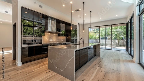 A modern kitchen showcasing clean lines, abundant natural light, marble countertops, and a seamless blend of functionality and style.